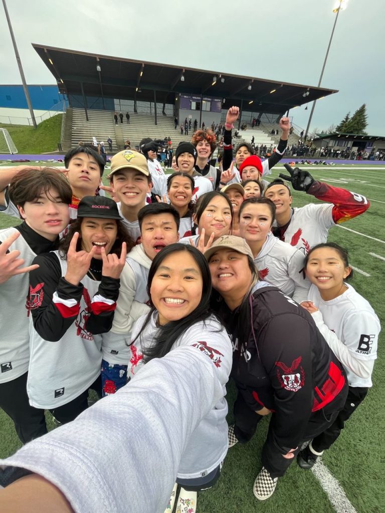 cleveland high school's mixed ultimate frisbee team takes a selfie with their coaches