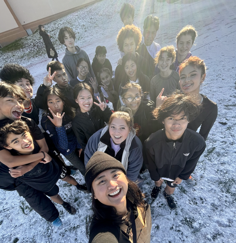 group of young bipoc kids pose for a selfie in the snow